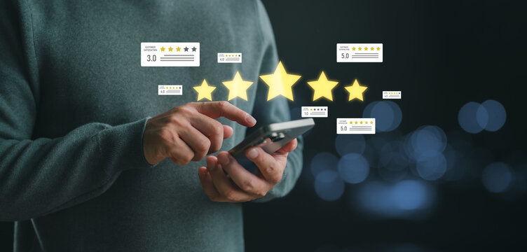 Man using smartphone to rate online service with five stars and customer feedback, concept of digital rating, review system, and client satisfaction for e-commerce and business platforms. - Powered by Adobe
