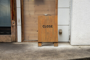 sorry we are closed sign hanging outside a restaurant, store, office or other