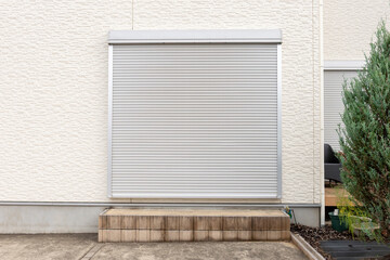 A closeup shot of automatic metal roller door used in factory, storage, garage, and industrial warehouse. The corrugated and foldable metal sheet offer space saving and provide urban and rustic feel