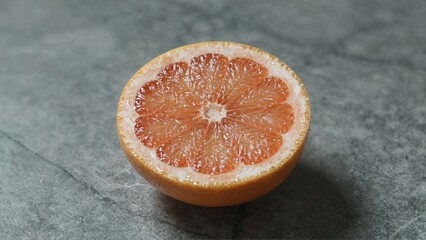 Halved orange on stone surface
