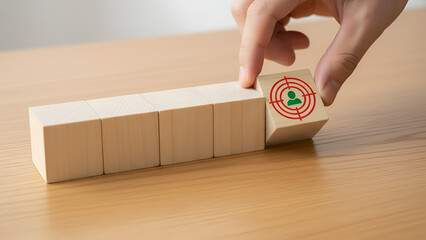 Hand Placing Target Block on Row of Wooden Blocks: Focus, Goals, and Target Setting

