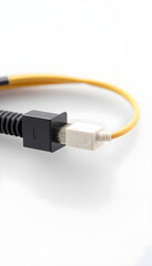 Ethernet cable with yellow sleeve and black connector on white background  