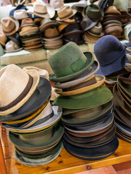 Collection of Various Hats Arranged on Surface in a Market Setting