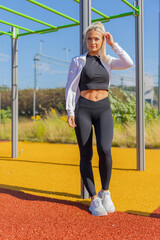 Woman Posing in Athletic Attire at an Outdoor Fitness Park