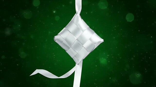White ribbon ketupat hanging on green background for Eid.