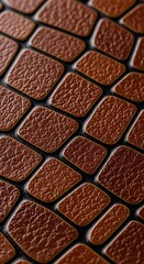 Fototapeta premium Close up view of brown leather pattern texture tiles with dark background.