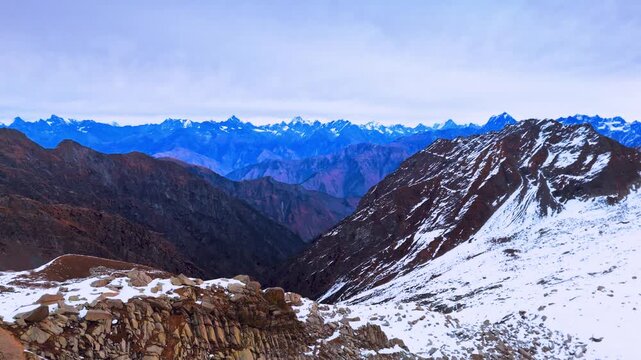 Drone view of Chamba Valley captured from Indrahar Pass. A cinematic aerial reveals deep valleys, rugged ridgelines, and vast Himalayan landscapes.