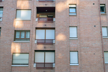 Brick Apartment Building Facade With Windows And Balconies In Urban Residential Architecture