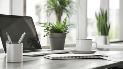 Fototapeta premium Modern home office setup with laptop, notebook, and coffee cup on wooden desk, symbolizing hybrid work. Minimalist decor with copy space, ideal for remote work and productivity concepts.