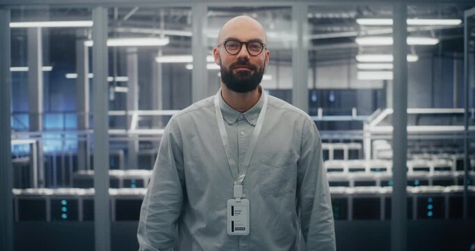 Technical Expert With Warm, Professional Expression in Blue Lit Environment Sand Metal Structures of Data Center Control Room. Technical Competency and Positive Professional Attitude. Portrait.