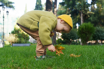 Toddler Child Lying and Smiling on Green Grass in Park