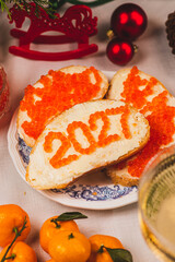A sandwich with butter and caviar. The figures for 2027 are laid out in dots.