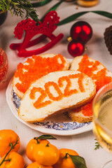 A sandwich with butter and caviar. The figures for 2027 are laid out in dots.