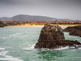 Rocky coastline in Arnuero, Cantabria on an overcast day