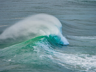 Powerful ocean wave breaking with spray in Nazar&eacute;