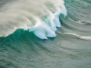 Ocean wave breaking with powerful water spray and foam
