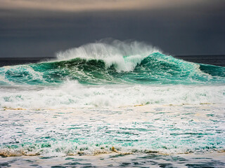 Big ocean wave breaking on stormy day in Nazar&eacute;