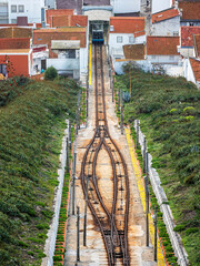 Funicular railway ascending hill through Nazar&eacute; city buildings