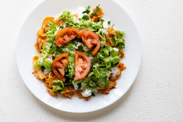 Close-Up of Chicken Kapsalon with Turkish Doner on White Plate