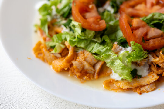 Close-Up of Chicken Kapsalon with Turkish Doner on White Plate