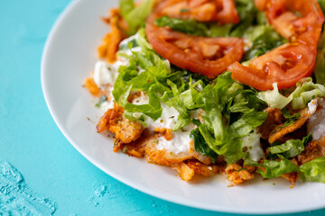 Close-Up of Chicken Kapsalon with Turkish Doner on White Plate