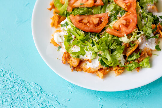 Close-Up of Chicken Kapsalon with Turkish Doner on White Plate