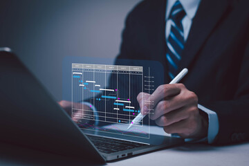 Business professional analyzing project timeline and data chart on digital interface. Concept of project management, business planning, data analysis, technology, and corporate strategy.