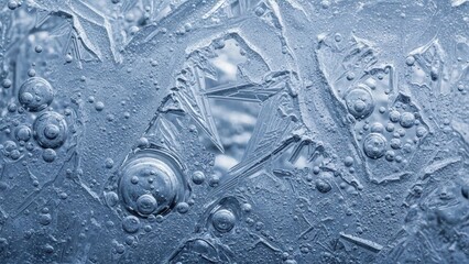 Intricate ice crystals with air bubbles in frosty blue background