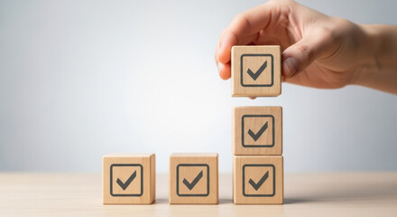 Close-up arrangement of wooden blocks with check marks, set against a clean white backdrop, symbolizes agreement, verification, and incremental success.