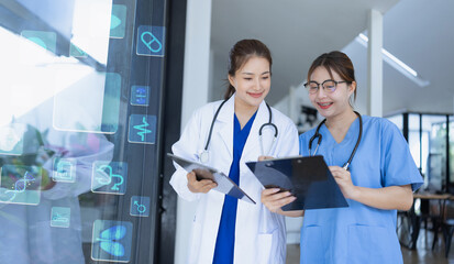Two asian female doctor with clipboard in modern clinic, Doctor woman working with human anatomy virtual interface icons in hospital.