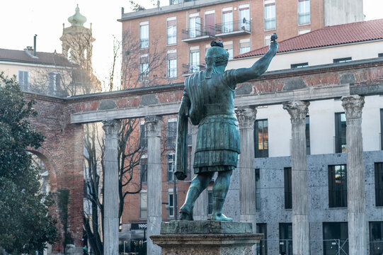 Bronze statue of Emperor Constantine, associated with the Edict of Milan (313) that proclaimed religious tolerance and freedom of worship in the Roman Empire, photographed with an ancient colonnade an