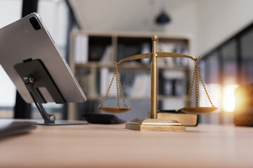 Golden balance scales symbolizing justice on desk at a law office, Law and justice concept.