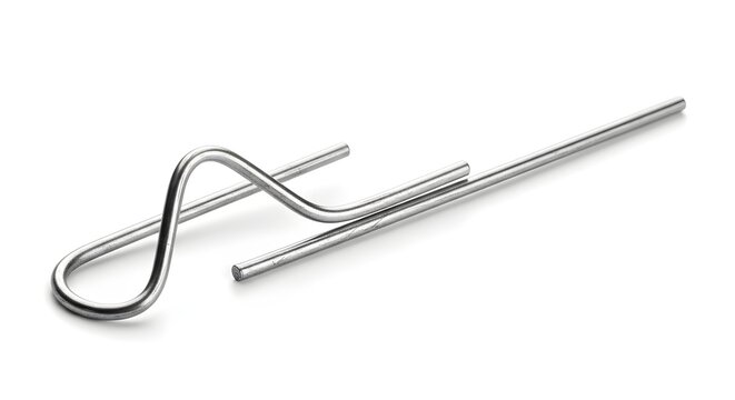 Close up of a silver metal spring clip or wire retainer part featuring intricate bending isolated on a clean white background studio shot