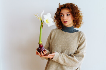 young woman with an amaryllis flower