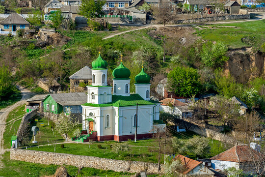 Surrounded by stone wall old church of the Transfiguration in Trebujeni village by early spring. Old Orheul, Moldova 