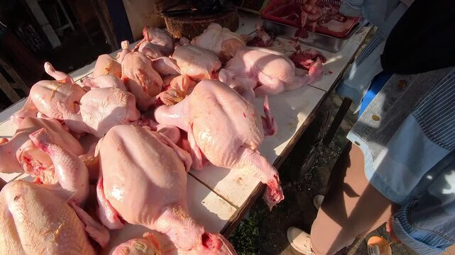 Clip of freshly cut chicken meat at chicken meat broilers in a traditional Indonesian market. Videography of buying chicken meat in a traditional market in 4K HD resolution.