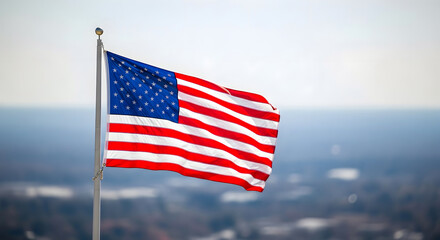 American flag waving on a flagpole with a cityscape background