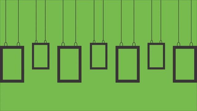 Various sizes of dark rectangular picture frames are artistically suspended by thin black wires against a vibrant solid green background suggesting a gallery display.