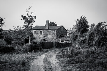 Traditional rural stone house with wooden gallery and slate roof