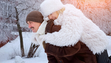 Couple Enjoying Snowy Day With Joyful Embraces, Joyful Pair Sharing Warmth Beneath Bright Sunlit Pine Branches, Happily Embracing Couple In Snowy Landscape Surrounded By Shining Sunlit Pine Trees