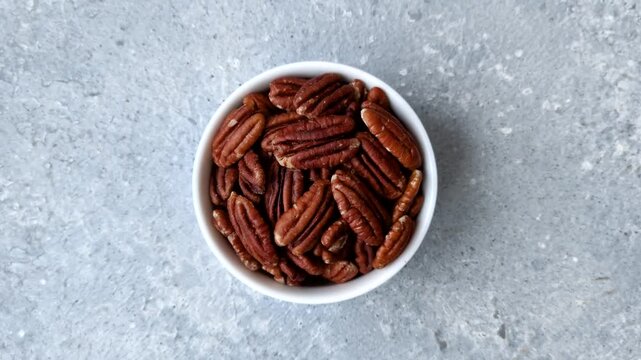 Peeled and roasted pecan nut as an ingredient for healthy foods and snacks. Pecan nut as a food background for your design.
