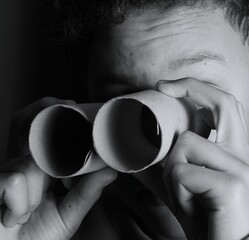 
child looking through binoculars on black background with people stock image stock photo
