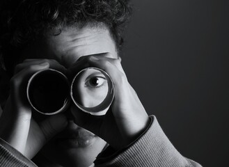 
child looking through binoculars on black background with people stock image stock photo
