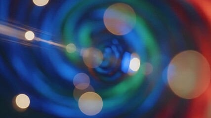 Dynamic abstract background featuring a mesmerizing swirl of vibrant blue green and red light with soft glowing bokeh circles creating a futuristic and energetic visual experience perfect for technol.