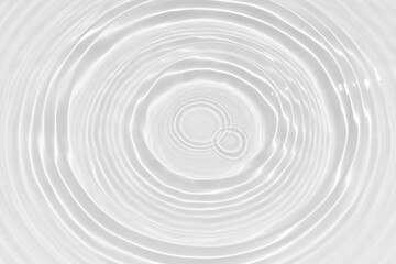 White water with ripples on the surface. Defocus blurred transparent white colored clear calm water surface texture with splashes and bubbles. Water waves with shining pattern texture background.