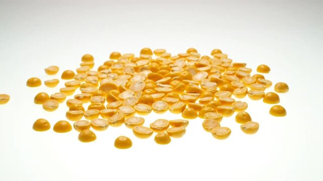 Close up view of split yellow peas on a white surface, ingredient for cooking healthy food