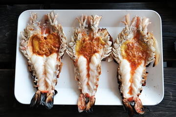 Grilled giant prawn and cutting half shrimp served on a white plate famous in Thai seafood.