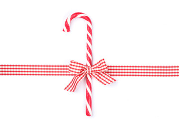Sweet candy cane with bow isolated on white background
