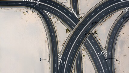 Aerial view of a complex highway interchange with multiple curving roads and intersections.