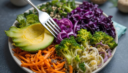 Colorful plate of fresh vegetables including avocado, broccoli, carrots, and purple cabbage, garnished with seeds, showcasing healthy eating and vibrant food presentation